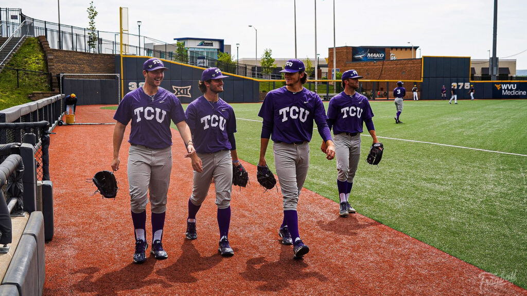 Horned Frogs Baseball players smiling as they walk back to the dugout for pre-game warmup against West Virginia in Morgantown, VA. 